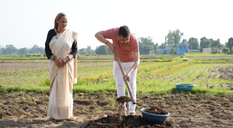Dhami Promotes Organic Farming, Ploughs Field at Khatima Residence